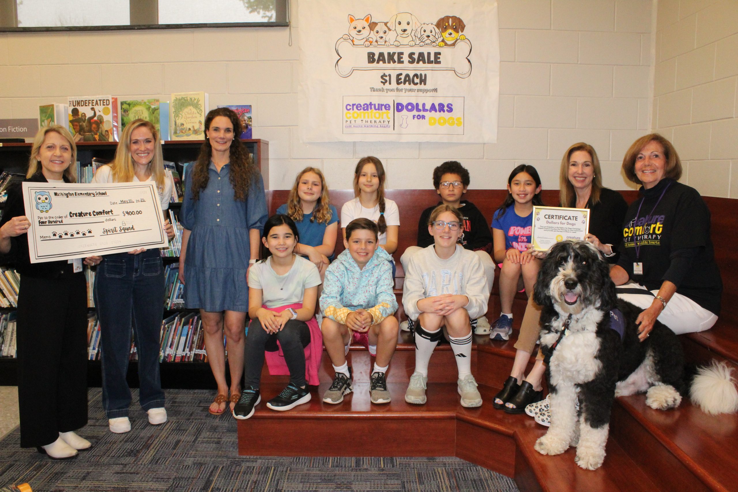 Children at Washington School in Summit presenting a check to Creature Comfort.